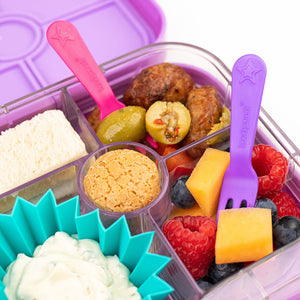 A zoomed in product shot of a lunch box of The Lunch Punch Fork & Spoon Set - Pink.