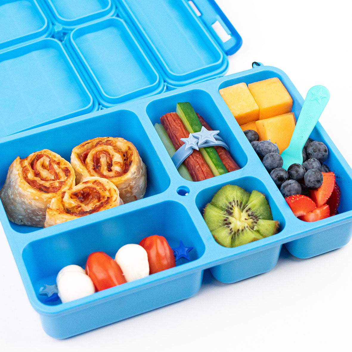 A blue bento style lunch box filled with food using The Lunch Punch food accessories.