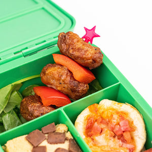 A zoomed in product shop in a lunch box of The Lunch Punch Stix - Pink used in a meatball kebab.
